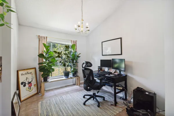 a view of a workspace with furniture and a window