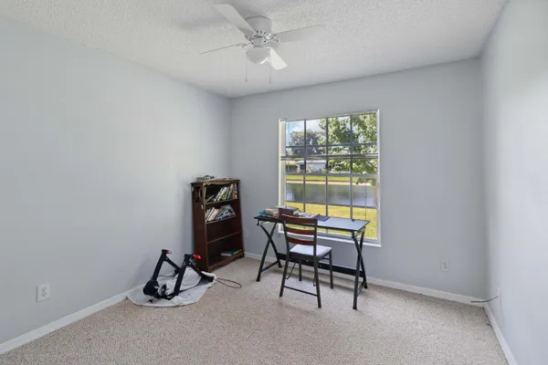 a view of a workspace with furniture and a window