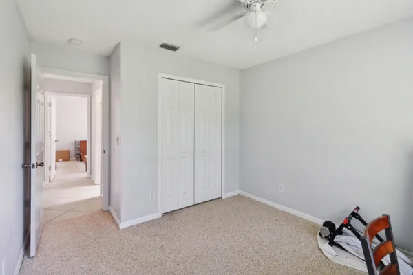 an empty room with a white walls and closet area