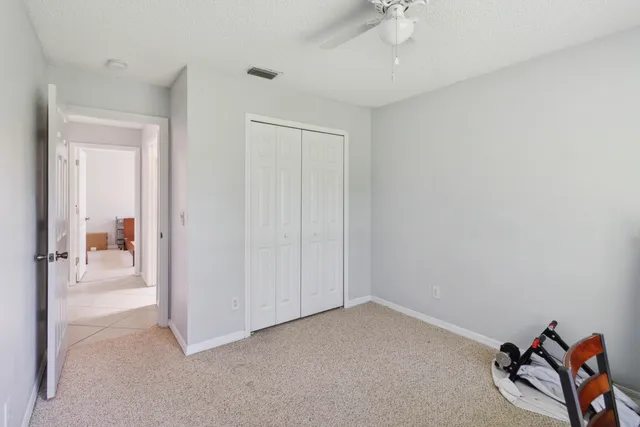 an empty room with a white walls and closet area
