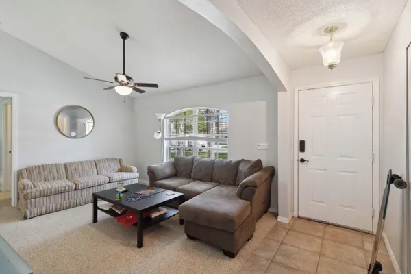 a living room with furniture and a chandelier