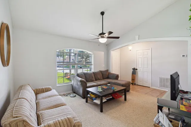 a living room with furniture and a chandelier