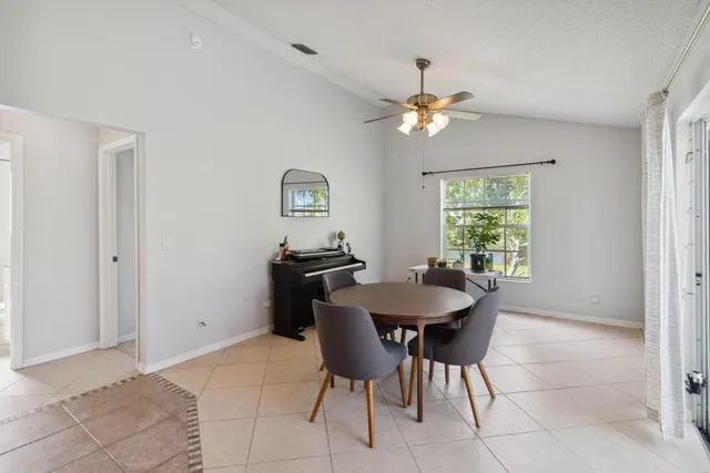 a dining room with furniture and a chandelier
