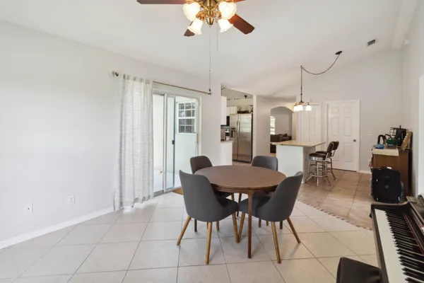 a dining room with furniture and window