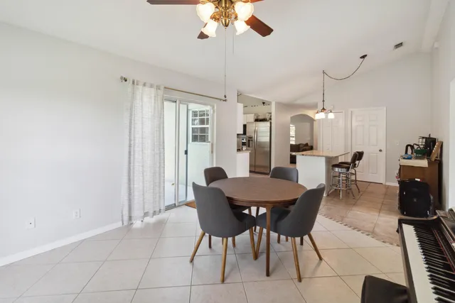 a dining room with furniture and window