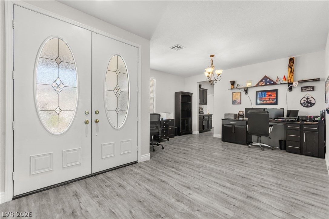 5601 Rocky Ravine Avenue Las Vegas, NV 89131 - Photo 11 of 71 Entrance foyer featuring light wood-style floors, a chandelier, and french doors