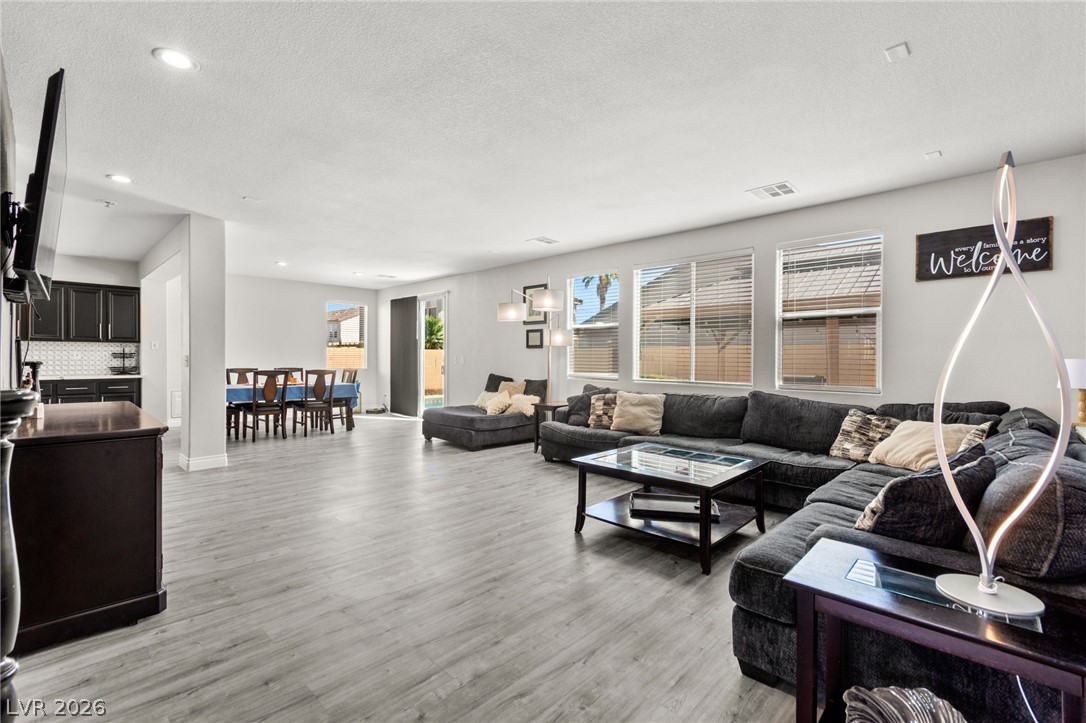 5601 Rocky Ravine Avenue Las Vegas, NV 89131 - Photo 15 of 71 Living room with a textured ceiling, light wood-type flooring, and recessed lighting