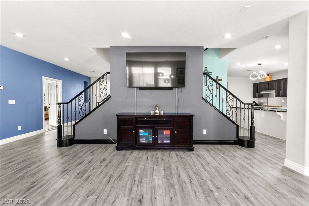 5601 Rocky Ravine Avenue Las Vegas, NV 89131 - Photo 16 of 71 Living room with light wood-style flooring and recessed lighting