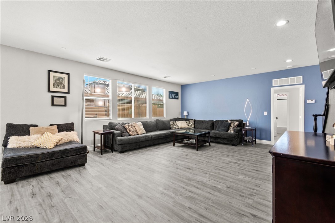 5601 Rocky Ravine Avenue Las Vegas, NV 89131 - Photo 18 of 71 Living area featuring light wood finished floors, a textured ceiling, and recessed lighting