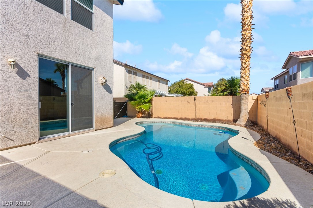 5601 Rocky Ravine Avenue Las Vegas, NV 89131 - Photo 25 of 71 View of pool featuring a fenced backyard and patio surround
