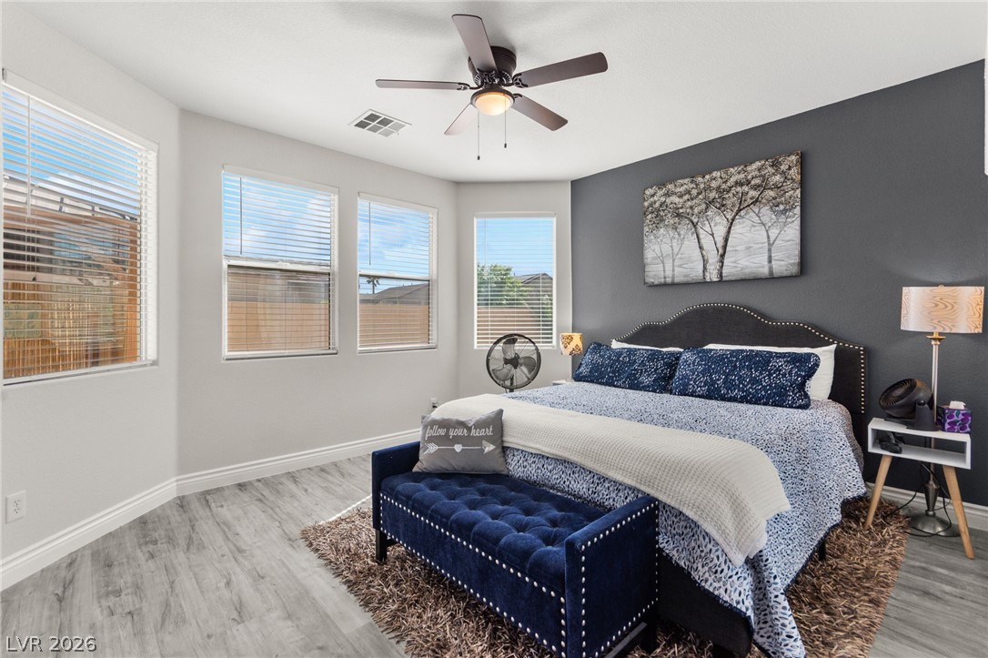 5601 Rocky Ravine Avenue Las Vegas, NV 89131 - Photo 31 of 71 Bedroom with light wood-type flooring and ceiling fan