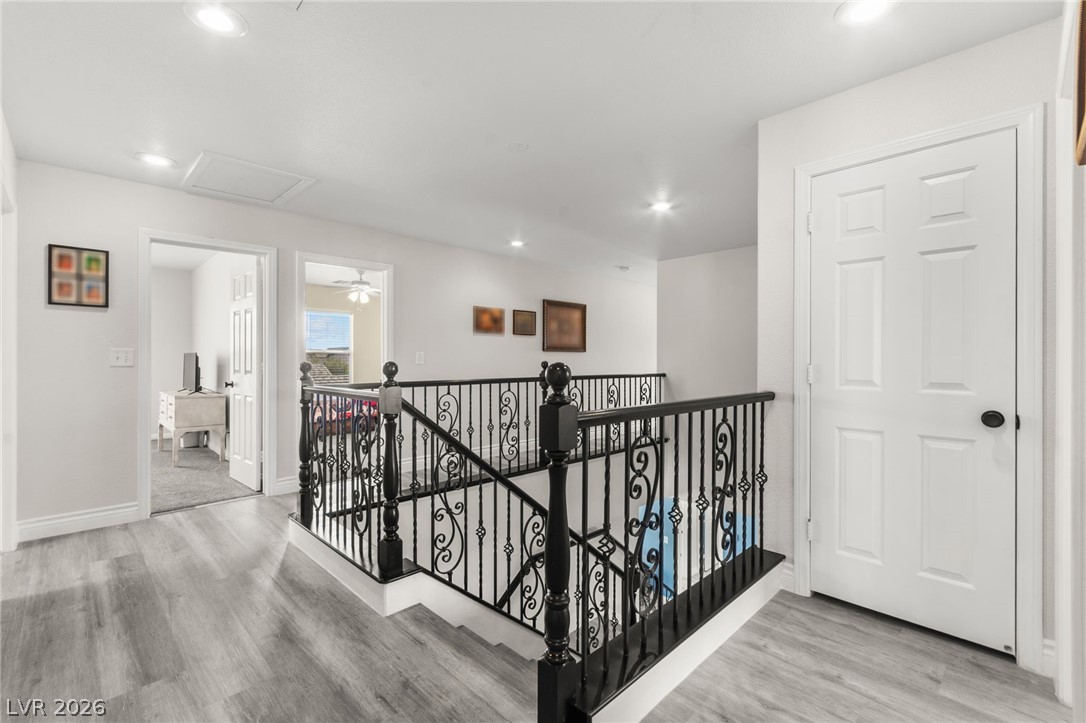 5601 Rocky Ravine Avenue Las Vegas, NV 89131 - Photo 36 of 71 Hall with an upstairs landing, light wood finished floors, and recessed lighting