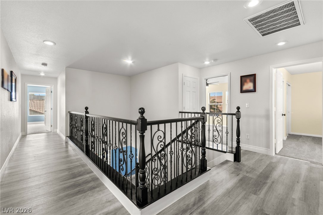 5601 Rocky Ravine Avenue Las Vegas, NV 89131 - Photo 37 of 71 Hall featuring an upstairs landing, light wood-style flooring, and recessed lighting