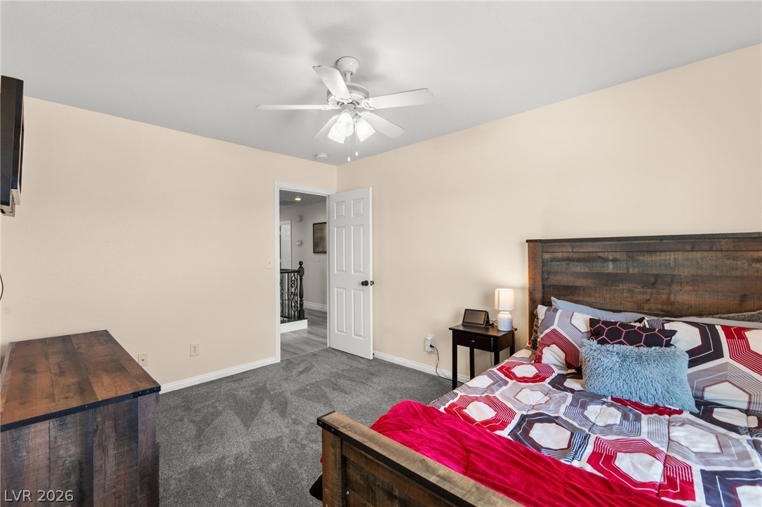 5601 Rocky Ravine Avenue Las Vegas, NV 89131 - Photo 52 of 71 Bedroom with dark carpet and ceiling fan