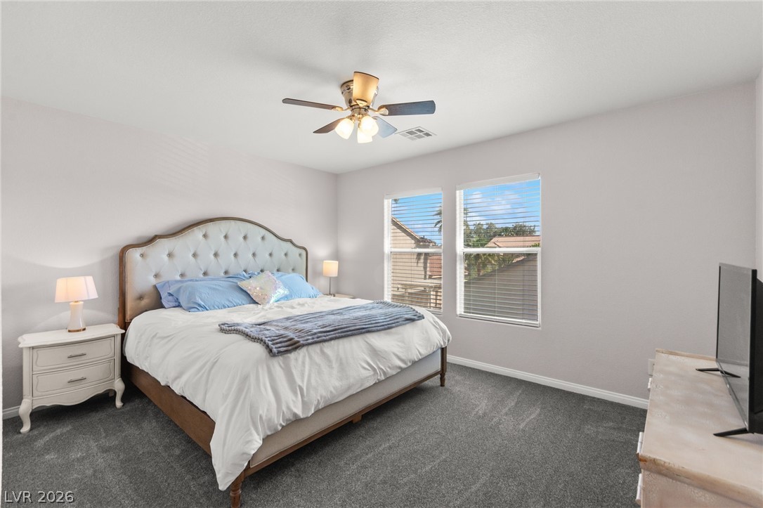 5601 Rocky Ravine Avenue Las Vegas, NV 89131 - Photo 53 of 71 Bedroom featuring dark colored carpet and ceiling fan
