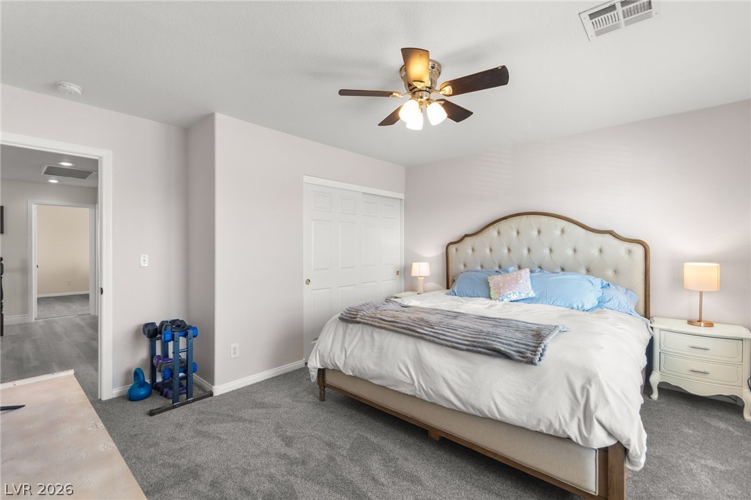 5601 Rocky Ravine Avenue Las Vegas, NV 89131 - Photo 54 of 71 Carpeted bedroom featuring a ceiling fan and a closet