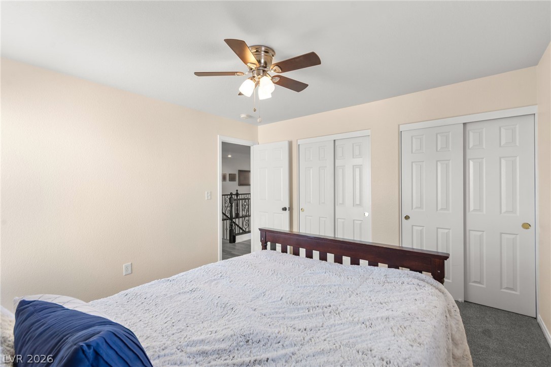 5601 Rocky Ravine Avenue Las Vegas, NV 89131 - Photo 58 of 71 Bedroom featuring two closets, carpet, and a ceiling fan