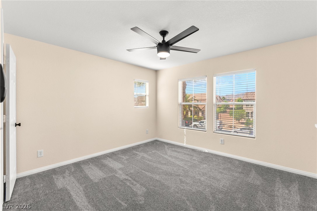 5601 Rocky Ravine Avenue Las Vegas, NV 89131 - Photo 60 of 71 Spare room featuring dark carpet and ceiling fan