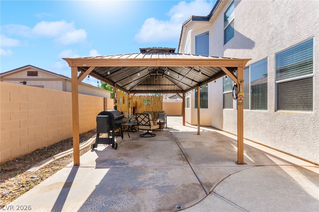 5601 Rocky Ravine Avenue Las Vegas, NV 89131 - Photo 64 of 71 Fenced backyard featuring a gazebo, a patio area, and grilling area