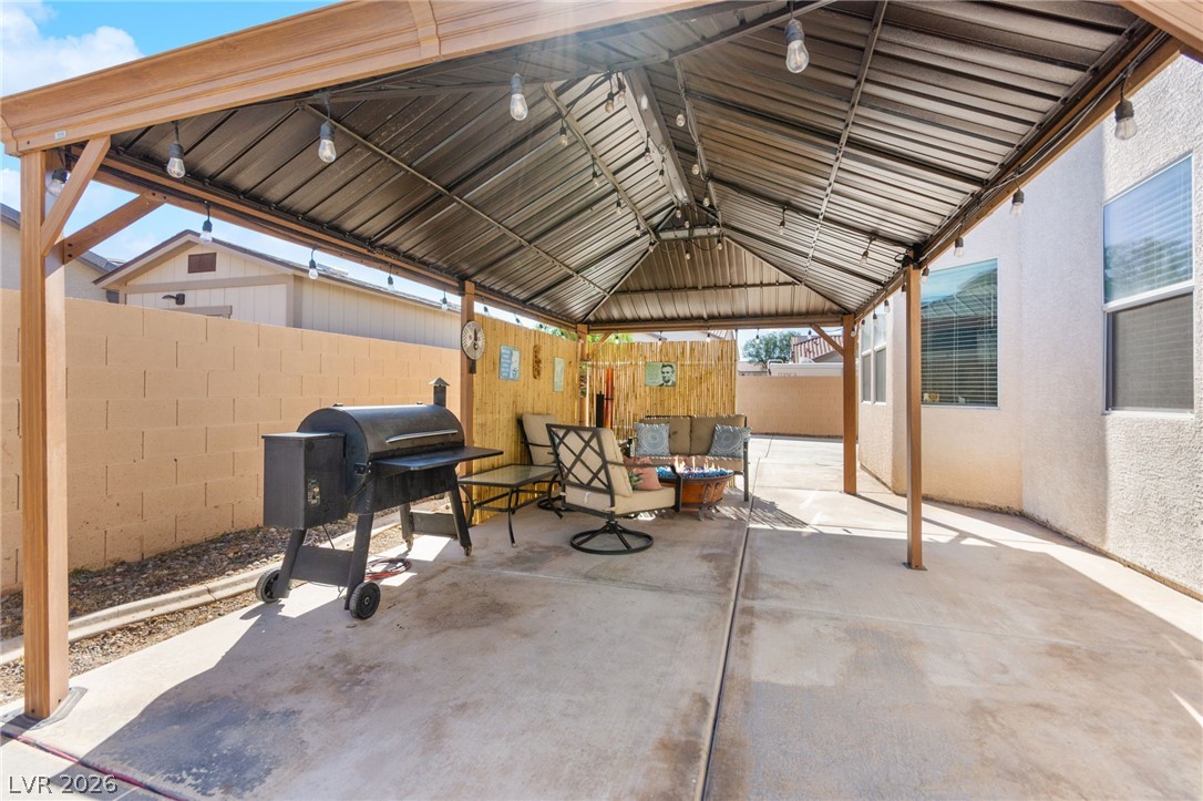 5601 Rocky Ravine Avenue Las Vegas, NV 89131 - Photo 65 of 71 Fenced backyard featuring a patio, a grill, and an outdoor hangout area