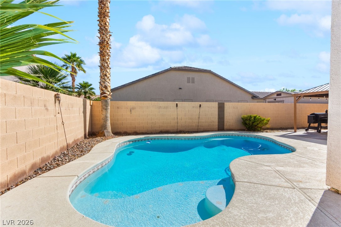5601 Rocky Ravine Avenue Las Vegas, NV 89131 - Photo 69 of 71 View of swimming pool with patio surround and a fenced backyard