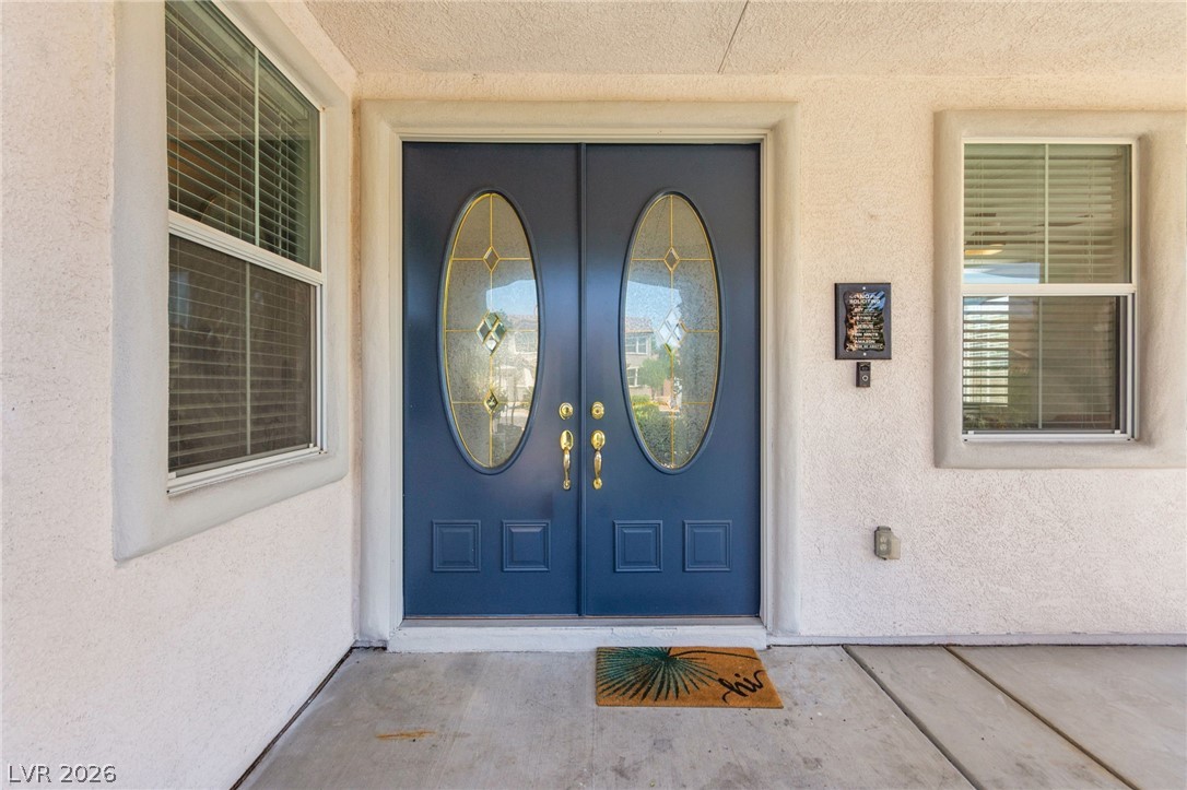 5601 Rocky Ravine Avenue Las Vegas, NV 89131 - Photo 10 of 71 Doorway to property with stucco siding and french doors