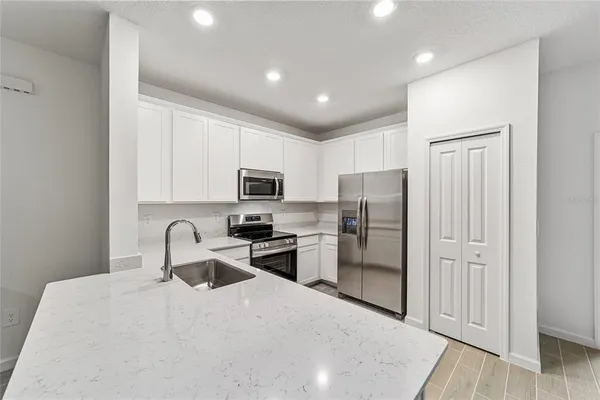 a view of kitchen and white bath tub