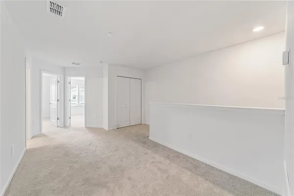 an empty room with windows and closet