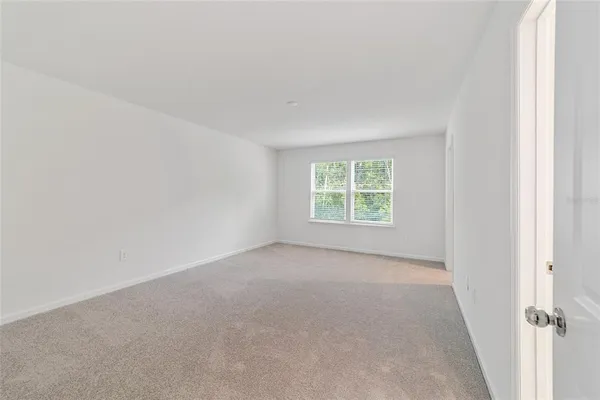 a spacious bathroom with a granite countertop sink a toilet and a large mirror