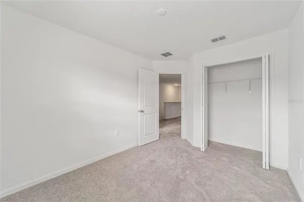 a view of room with stairs and white walls