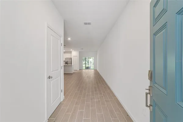a view of a hallway with wooden floor