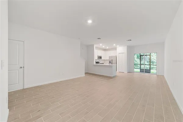 a view of kitchen with refrigerator sink and cabinets