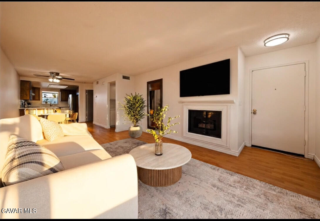 20345 Rue Crevier, Unit 507 Santa Clarita, CA 91351 - Photo 7 of 20 a living room with furniture a flat screen tv and a fireplace
