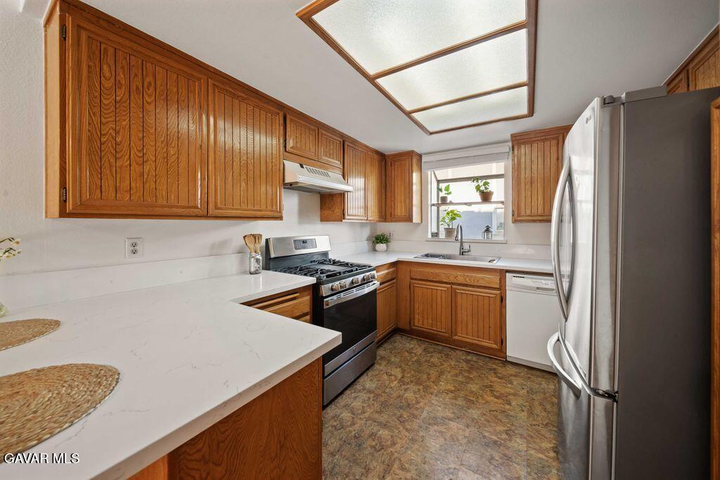 20345 Rue Crevier, Unit 507 Santa Clarita, CA 91351 - Photo 8 of 20 a kitchen with a sink a stove a refrigerator cabinets a sink and a counter top space