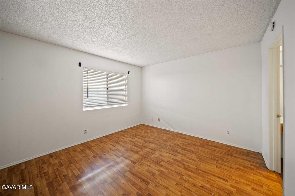 20345 Rue Crevier, Unit 507 Santa Clarita, CA 91351 - Photo 10 of 20 a view of empty room with wooden floor and fan