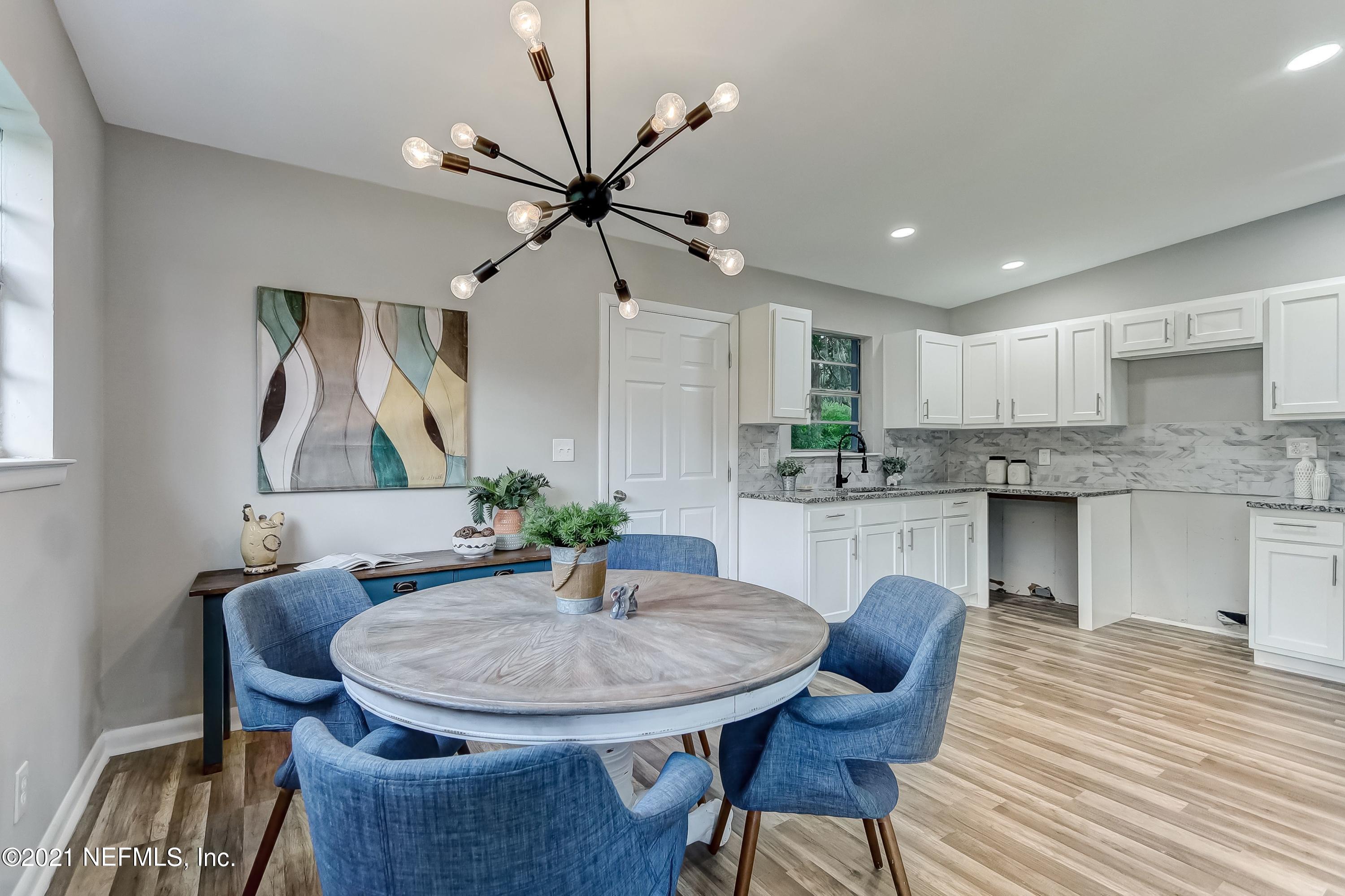 6914 Rollo Road Jacksonville, FL 32205 - Photo 15 of 31 a view of a dining room with furniture and wooden floor