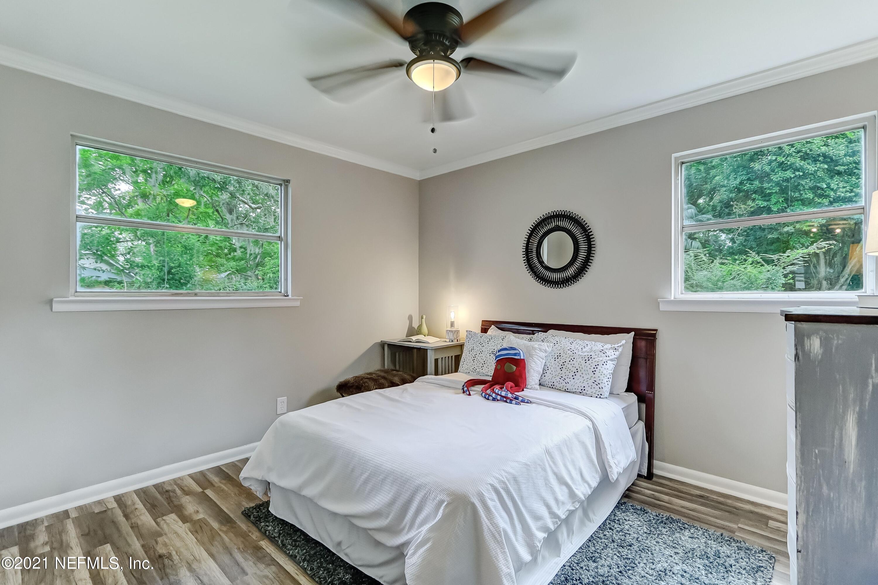 6914 Rollo Road Jacksonville, FL 32205 - Photo 19 of 31 a bedroom with a bed and a window