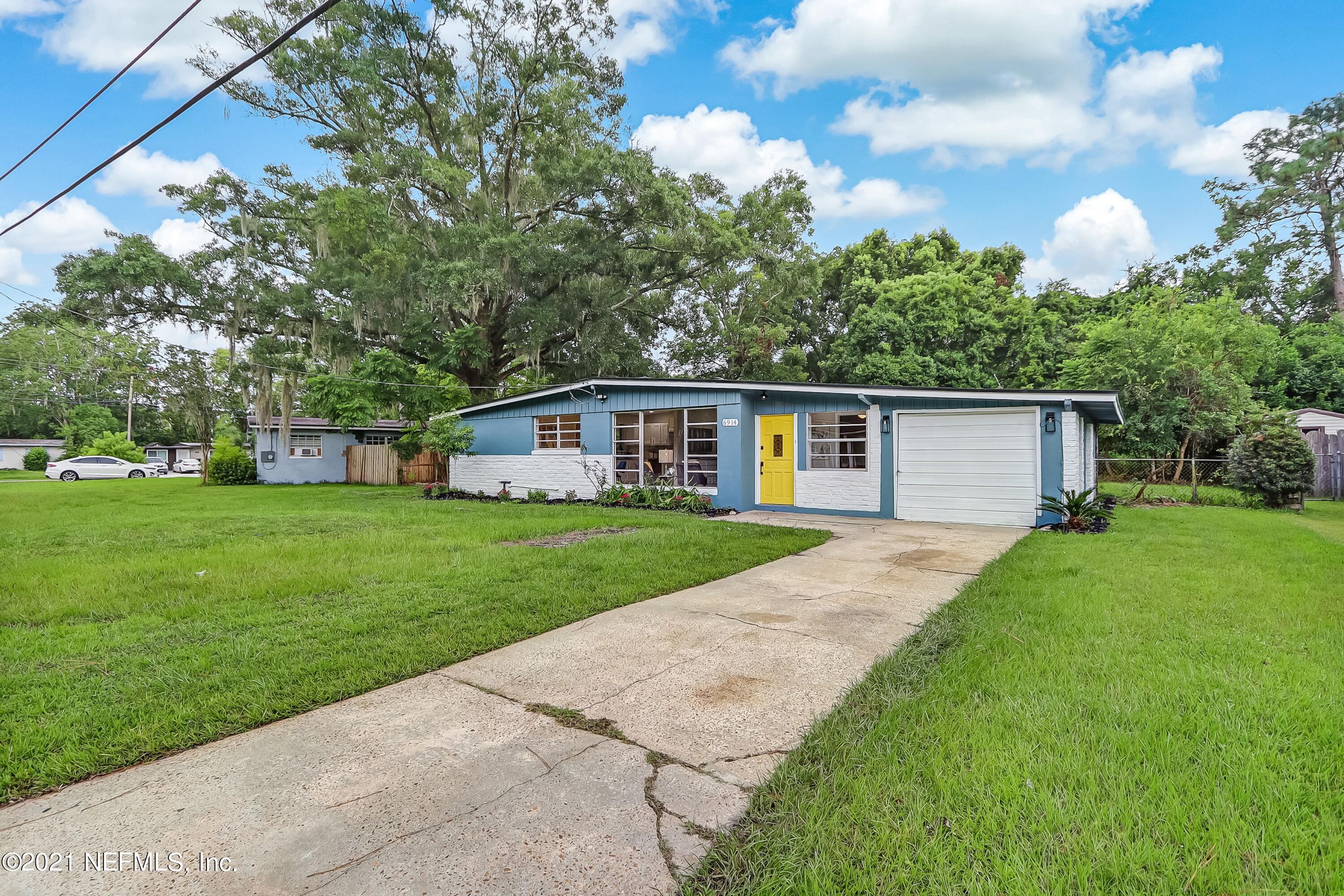 6914 Rollo Road Jacksonville, FL 32205 - Photo 2 of 31 a front view of a house with garden