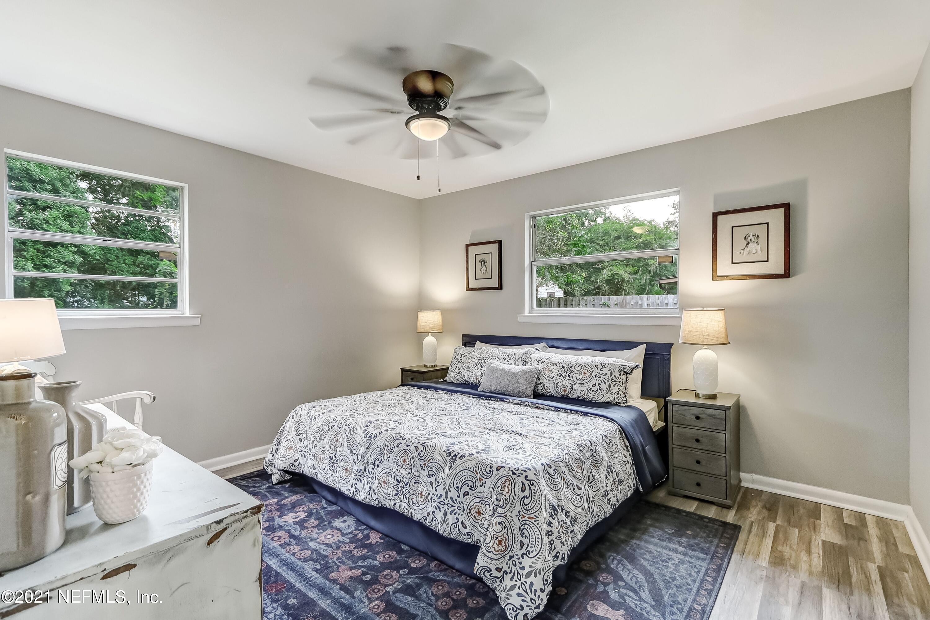 6914 Rollo Road Jacksonville, FL 32205 - Photo 21 of 31 a bedroom with a bed and a window