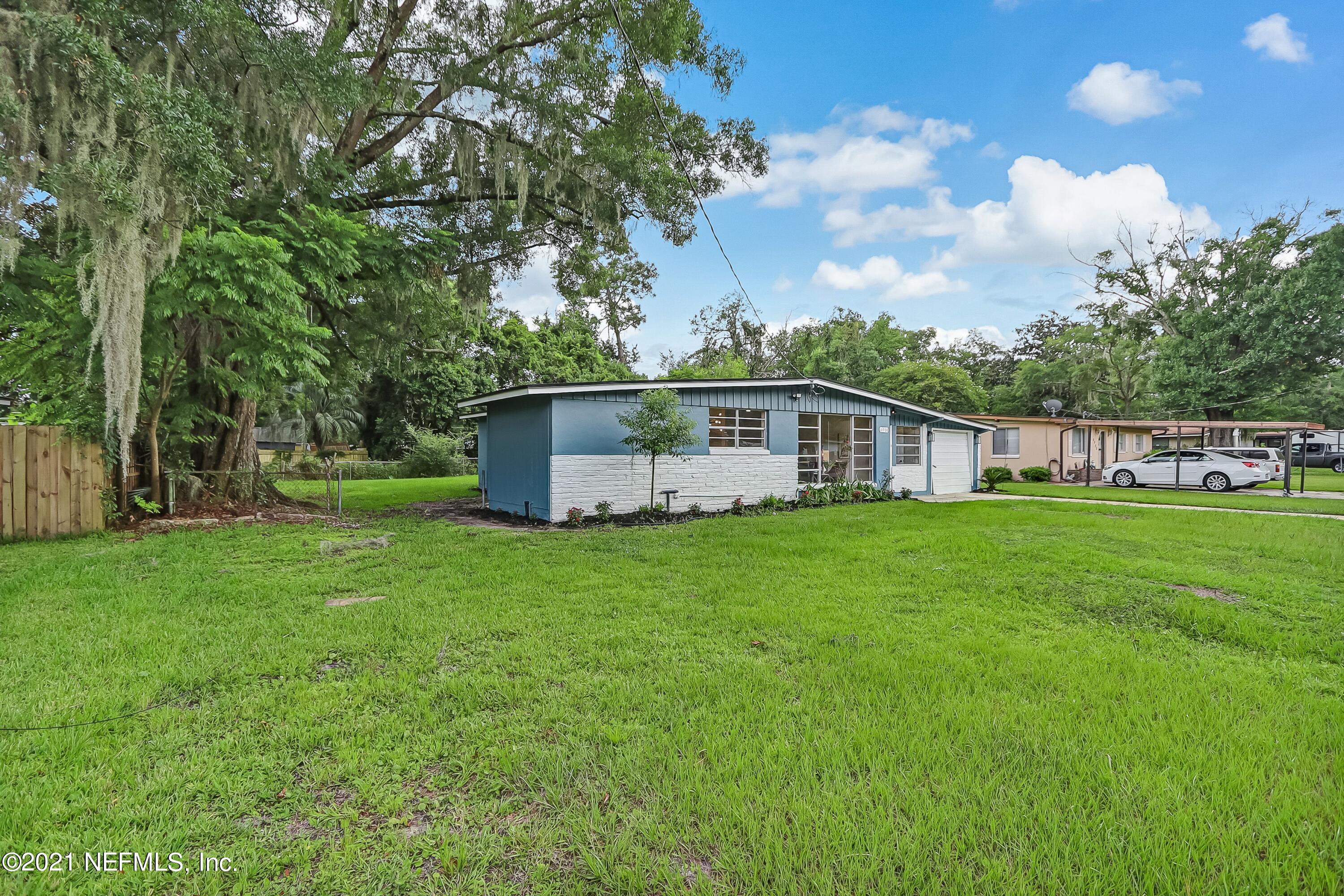 6914 Rollo Road Jacksonville, FL 32205 - Photo 3 of 31 a view of a house with backyard and garden