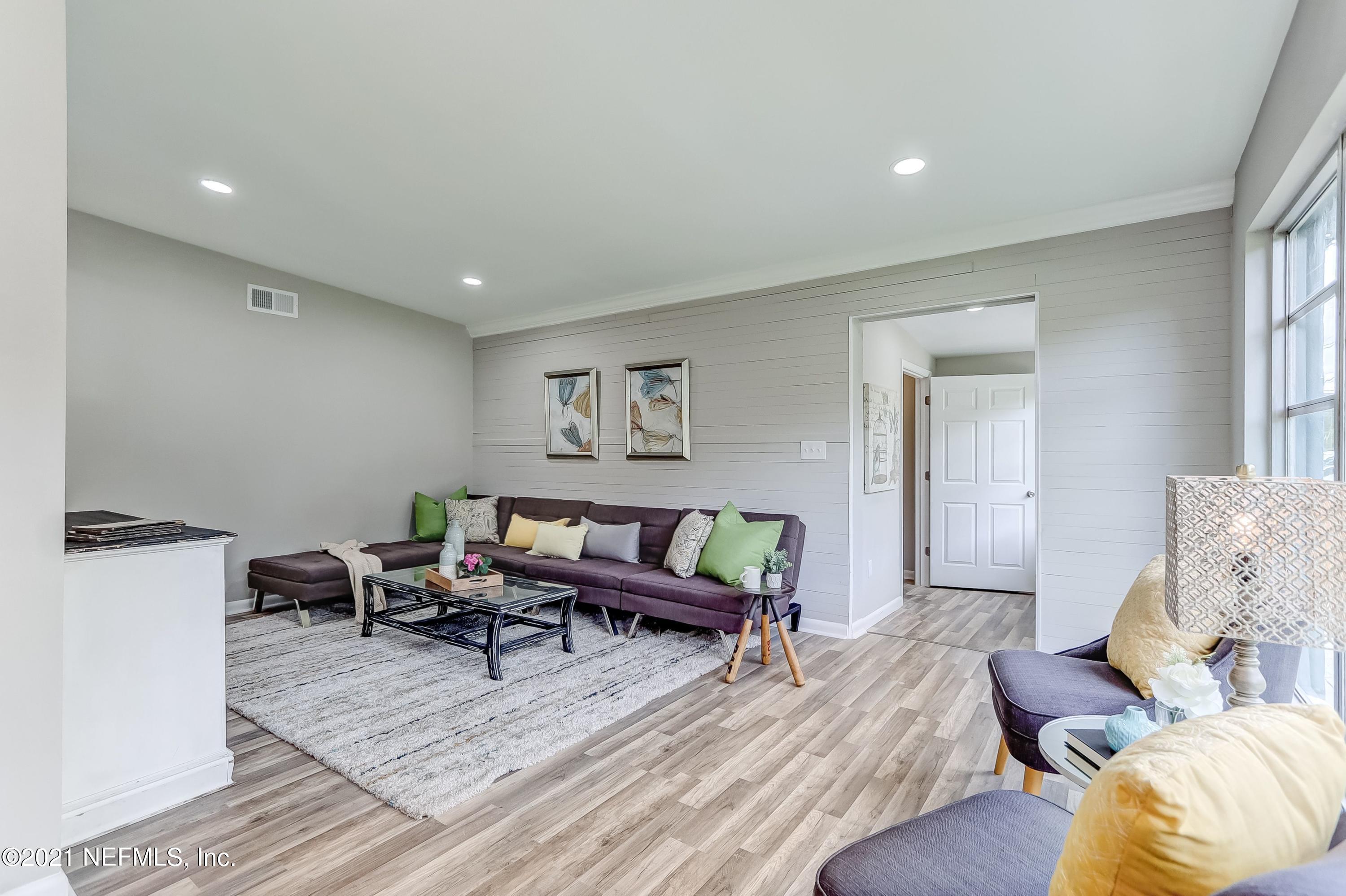 6914 Rollo Road Jacksonville, FL 32205 - Photo 9 of 31 a living room with furniture and a wooden floor
