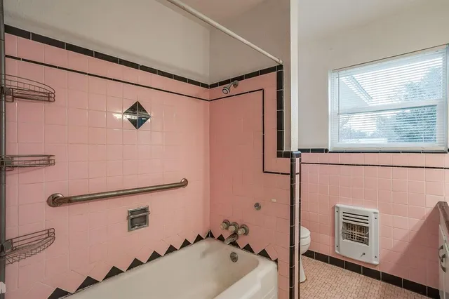 a bathroom with a tub and a window