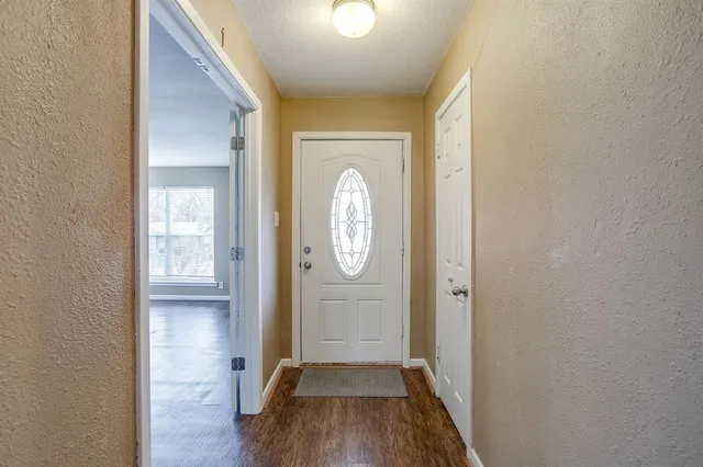 a view of hallway with wooden floor