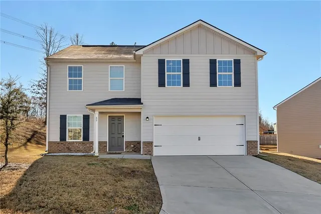a front view of a house with a yard and garage