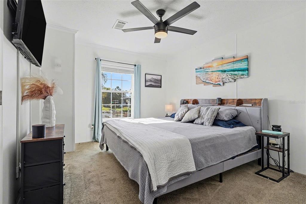 11305 Pineapple Road Punta Gorda, FL 33955 - Photo 12 of 30 a bedroom with a bed and a flat screen tv