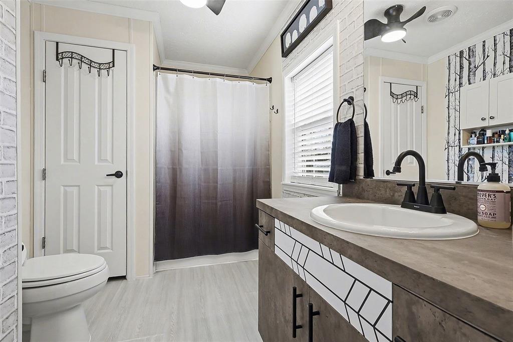 11305 Pineapple Road Punta Gorda, FL 33955 - Photo 13 of 30 a bathroom with a sink a toilet and shower curtain