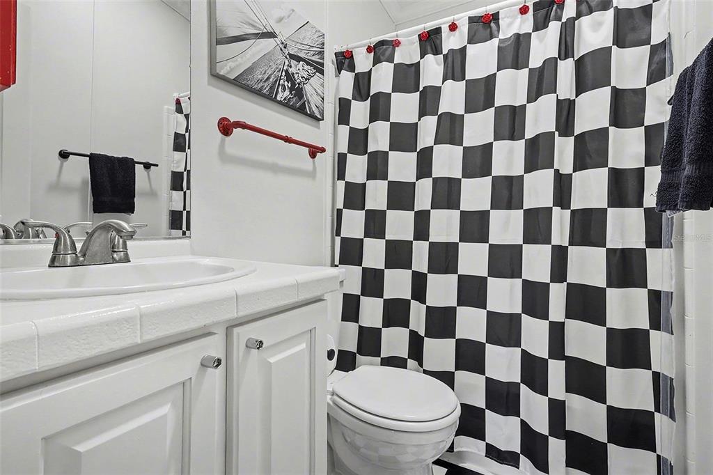 11305 Pineapple Road Punta Gorda, FL 33955 - Photo 16 of 30 a bathroom with a granite countertop toilet a sink and a mirror
