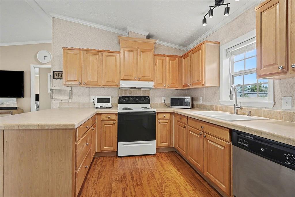 11305 Pineapple Road Punta Gorda, FL 33955 - Photo 10 of 30 a kitchen with stainless steel appliances granite countertop a sink a stove and cabinets