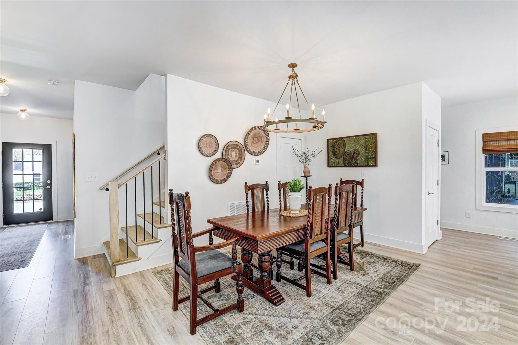 526 Seldon Drive Charlotte, NC 28216 - Photo 16 of 46 a view of a dining room with furniture wooden floor and chandelier