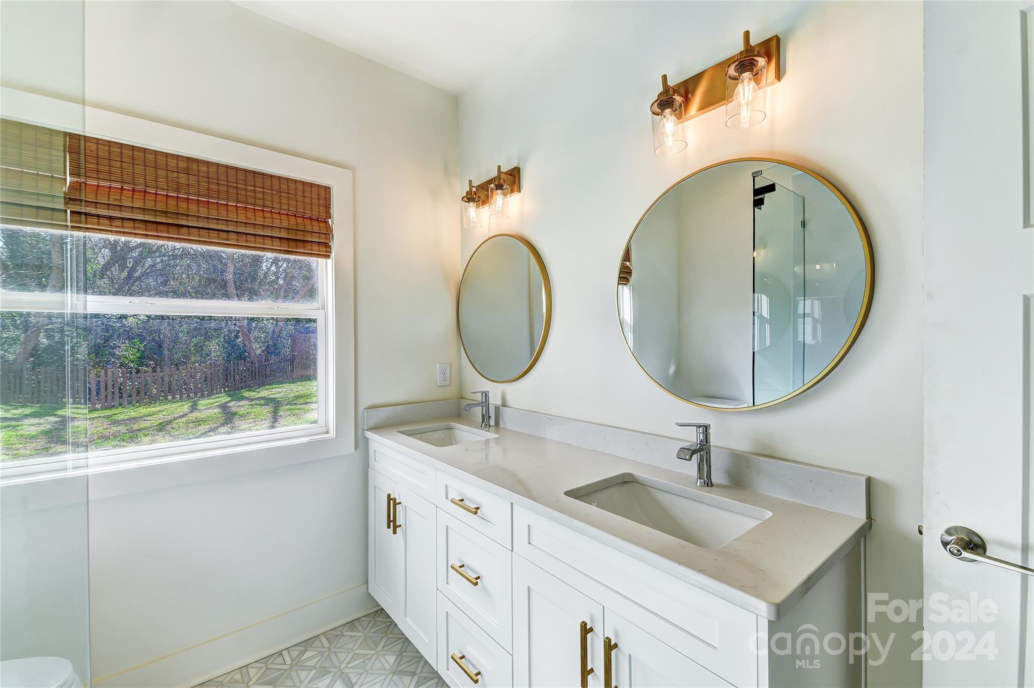 526 Seldon Drive Charlotte, NC 28216 - Photo 21 of 46 a bathroom with a granite countertop toilet a sink and a mirror